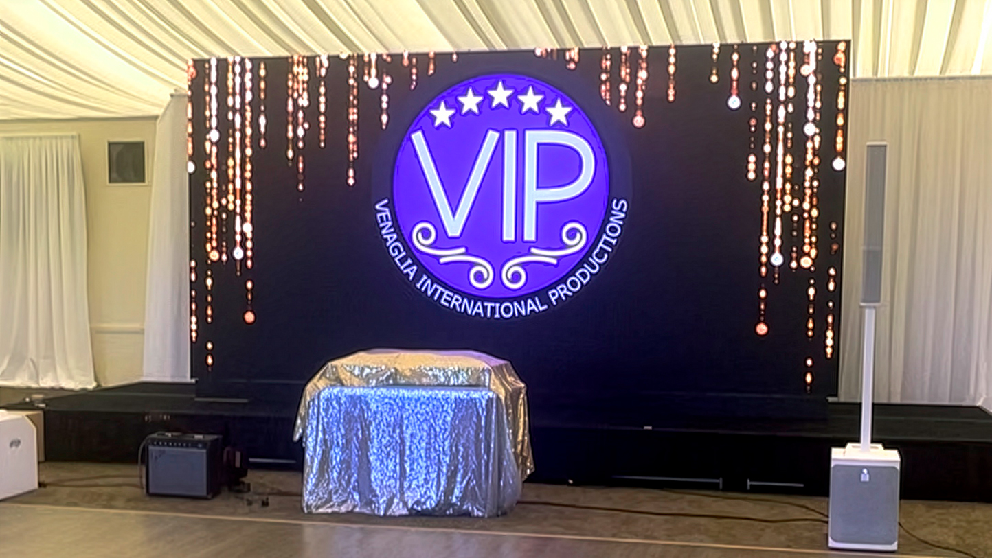 The dance floor at a wedding reception. Awaiting the bride and groom to make their entrance. A large LED display shows our promotional logo.